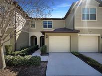 Townhome boasts a well-maintained exterior and attached garages at 3020 Alessa Loop, Apopka, FL 32703