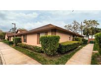 Charming corner-unit home featuring lush landscaping and well-maintained exterior at 358 Douglas Way # 78, Winter Garden, FL 34787