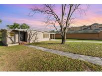 Charming single-story home featuring a well-maintained lawn and mature tree at 3905 Cherry Way, Lakeland, FL 33805