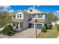Charming two-story home featuring a well-manicured lawn and a welcoming front porch at 4107 Briar Gate Ln, Winter Garden, FL 34787