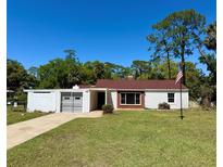Charming single-story home featuring a well-maintained lawn and attached carport at 472 Rosalia Dr, Sanford, FL 32771