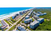 Stunning aerial view of beach condos, offering beautiful oceanfront living and resort-style amenities at 5300 S Atlantic Ave # 7-301, New Smyrna Beach, FL 32169