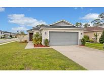 Charming single-story home with a well-manicured lawn and a spacious two-car garage at 600 Bullrush Ct, Davenport, FL 33837