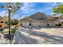 Charming townhome with attached garages and a decorative brick-lined driveway, offering curb appeal and convenience at 7781 Sugar Bend Dr # 7781, Orlando, FL 32819