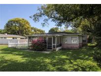 Charming single-story home with a welcoming screened porch and a well-maintained lawn at 1016 E Fillmore Ave, Orlando, FL 32809