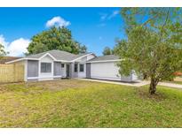 Charming single-story home featuring a well-manicured lawn and neutral tones, blending comfort with curb appeal at 150 Chicago Woods Cir, Orlando, FL 32824