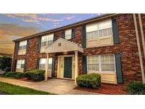 Two-story brick building with multiple windows and a covered entrance, showcasing classic architectural style at 1920 E Edgewood Dr # A9, Lakeland, FL 33803