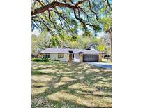 Charming single-story home featuring a two-car garage and elegant stone accents at 5374 Crooked Oak Cir, St Cloud, FL 34771