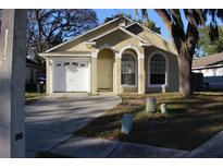 Charming single-Gathering home with a well-maintained lawn and attached garage, creating inviting curb appeal at 6321 Redwood Oaks Dr, Orlando, FL 32818