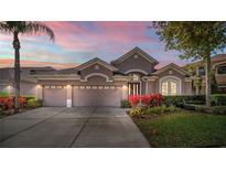 Charming home with a three-car garage, beautiful landscaping, and a well-manicured lawn at 6854 Remington View Ct, Orlando, FL 32829