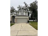 Well-maintained two-story home with a two-car garage and tidy front yard landscaping at 178 Chippendale Ter, Oviedo, FL 32765