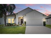 Charming single-story home featuring a well-manicured lawn and a welcoming front porch at 1822 Castleton Dr, St Cloud, FL 34771