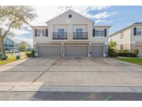 Well maintained exterior with grey garage doors, neutral paint, and second story balconies at 6612 S Goldenrod Rd # 104A, Orlando, FL 32822