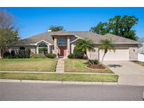 Charming single-story home with brick accents, mature landscaping, and a well-manicured lawn at 907 Almond Tree Cir, Orlando, FL 32835