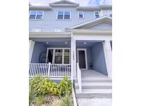 Charming two-story townhome featuring a cozy porch and well-maintained landscaping at 1284 Spotted Sandpiper Loop, Winter Springs, FL 32708