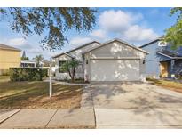 Charming single-Gathering home featuring a well-manicured lawn and two-car garage at 13212 Briar Forest Ct, Orlando, FL 32828