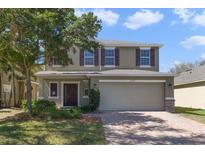 Charming two-story home featuring a well-maintained lawn and a two-car garage at 16217 Saint Augustine St, Clermont, FL 34714