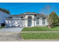 Charming single-story home with well-maintained lawn and blue trim, enhancing its curb appeal at 1817 Snaresbrook Way, Orlando, FL 32837