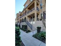 Attractive condo with balconies, front stairs, black railings, and well-manicured landscaping at 3345 Messina Dr, Lake Mary, FL 32746