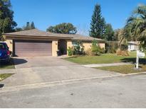 Charming single-story home with a manicured lawn and an attached two-car garage in a residential neighborhood at 5132 Goldenrod Place Rd, Winter Park, FL 32792