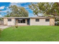 Charming single-story home with well-maintained lawn and stone accents at 606 Forest Dr, Casselberry, FL 32707