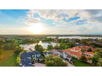 Stunning aerial view of a luxurious waterfront community with beautiful homes and lush greenery at 8336 Boyla Ct, Windermere, FL 34786