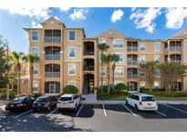 Beautiful three-story condo building with beige exterior and well-maintained landscaping at 2784 Almaton Loop # 301, Kissimmee, FL 34747