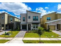 Beautiful contemporary two-story home with modern design, landscaping, and inviting curb appeal at 2807 Bookmark Dr, Kissimmee, FL 34746