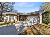 Charming home features a two-car garage, quaint front patio and well-maintained landscaping at 2940 Moore Dr, Oviedo, FL 32765