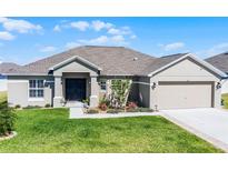 Charming single-story home with well-manicured lawn and inviting entrance at 427 Lanham Dr, Winter Haven, FL 33881