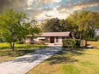 Charming one-story brick home with a well-maintained lawn and a long driveway at 46 Smyrna Dr, Debary, FL 32713