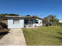 Charming single-story home with a well-maintained front yard and a concrete driveway at 655 Katherine Ave, Orlando, FL 32810