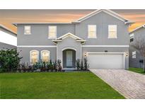 Charming two-story home features a well-manicured lawn, an attached two car garage, and a welcoming front entrance at 965 Talon Pl, Winter Springs, FL 32708