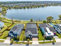 Stunning aerial view of waterfront homes, showcasing pools and lake access at 13059 Stoddart Ave, Orlando, FL 32827