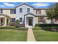 Charming two-story townhouse with well-manicured lawn and inviting entryway at 1325 Seburn Rd, Apopka, FL 32703
