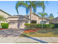 Charming single-story home featuring a two-car garage and mature landscaping at 1549 Balsam Willow Trl, Orlando, FL 32825