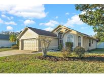 Charming single-story home featuring a well-manicured lawn and an attached two-car garage at 1600 Riveredge Rd, Oviedo, FL 32766