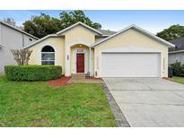 Charming single-story home with a well-manicured lawn and a two-car garage at 1669 Slash Pine Pl, Oviedo, FL 32765