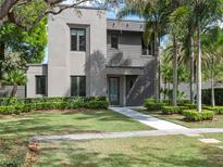 Striking modern home with well-maintained lawn, lush landscaping, and a stylish gray facade at 1970 Laurel Rd, Winter Park, FL 32789
