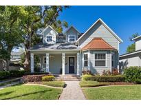 Beautiful two story home with a well maintained lawn, lovely landscaping, inviting front porch and a brick walkway at 2109 E Central Blvd, Orlando, FL 32803