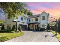 Beautiful two-story home featuring a basketball hoop and lush landscaping at 2536 Brookshire Ave, Winter Park, FL 32792