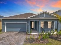 Charming single-Gathering home with a well-manicured front yard and a welcoming front porch with chairs at 338 Crestwind Dr, Daytona Beach, FL 32124