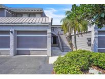 Charming townhome featuring a garage, private entry staircase, and mature landscaping at 5122 Cypress Creek Dr # 103, Orlando, FL 32811
