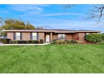 Charming brick home with a well-manicured lawn and inviting front entrance at 650 N 4Th Ave, Deltona, FL 32725