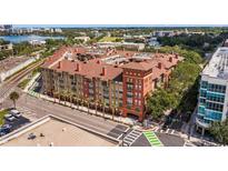 A beautiful view of a modern apartment building with street access and train tracks nearby at 911 N Orange Ave # 447, Orlando, FL 32801