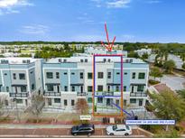 Beautiful three-story townhome featuring a modern design with a two-car parking in a well-maintained community at 927 City Walk Ln, Oviedo, FL 32765