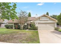 Charming single-Gathering home with a two-car garage and well-maintained front yard landscaping at 1072 Weaver Dr, Oviedo, FL 32765