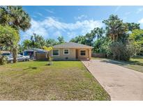 Charming single-story home featuring a well-maintained lawn and a long driveway at 1101 S Thompson Ave, Deland, FL 32720