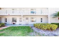 Inviting two-story condo with a white exterior, balcony, and well-maintained landscaping at 1140 S Orlando Ave # F-3, Maitland, FL 32751