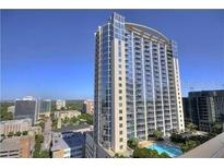 High-rise condo building featuring modern architecture, glass windows, and surrounding city views at 155 S Court Ave # 1613, Orlando, FL 32801